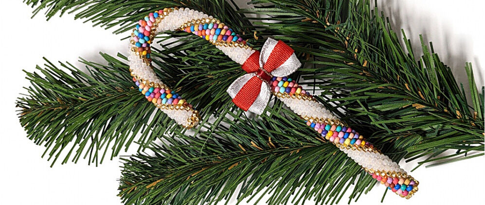 A beaded candy cane on a fir bough 
